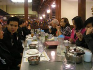 students and teachers eating at restaurant